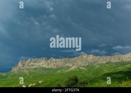 dark stormy sky over a mountain range. Panoramic view of the rocks. toned Stock Photo
