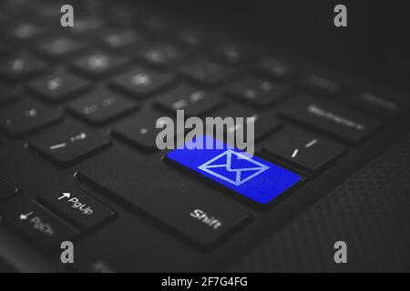 Connect and online communication concept. Email icon on blue laptop keyboard Stock Photo