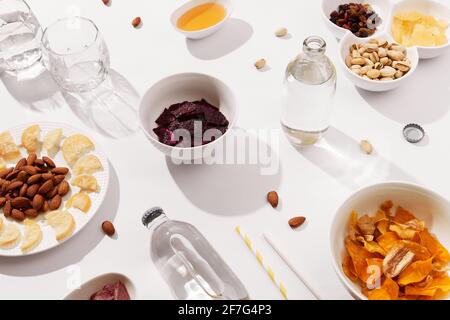 Dried fruits and nuts with sauce on white background with sunlight Stock Photo