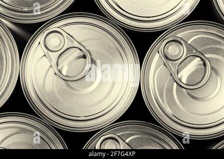 Close, top down view of many easy open metal tin cans in sepia tone Stock Photo