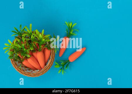Easter pattern made with carrots on blue background. Minimal Easter composition. Flat lay. Stock Photo