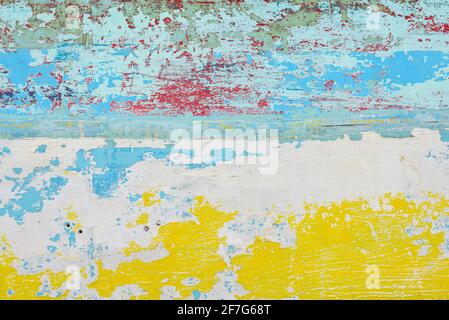 Abstract paint background with random patterns of layers of aged and weathered paint on a wood surface Stock Photo