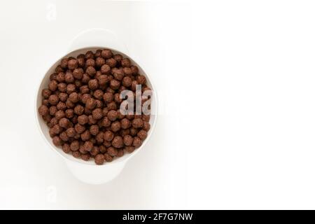 Chocolate cereal bowl isolated on white background. Chocolate balls. Breakfast. Stock Photo