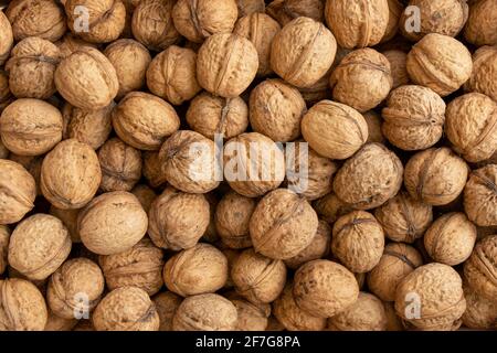 walnut background pattern texture, walnuts heap pattern, food in-shell nuts, scattered pile of walnuts, top view Stock Photo