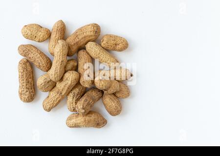 Peanuts or groundnuts in shells, isolated on white background. Unshelled nuts. Stock Photo