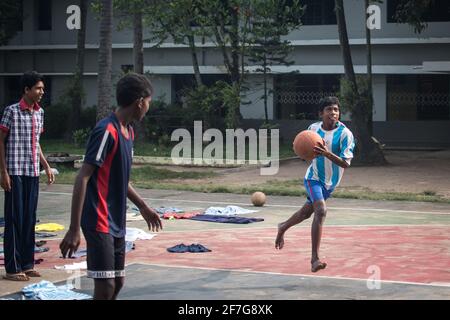 Varanasi, India. 10-16-2019. Group of male adolescents are playing basket at the school premises in Varanasi. Stock Photo