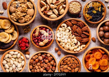 Various Nuts and dried fruits in wooden bowls, top view. Stock Photo