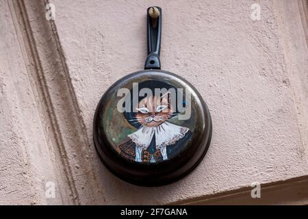 04.04.2021 Russia. Vyborg Drawing of a cat on a frying pan hanging on the wall of the house. High quality photo Stock Photo