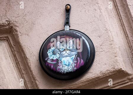 04.04.2021 Russia. Vyborg Drawing of a cat on a frying pan hanging on the wall of the house. High quality photo Stock Photo