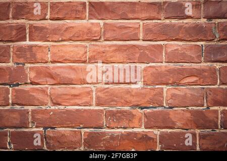 Red brick wall, bricks background, grunge texture. Decorative tile surface. Rough brickwork. Brown wallpaper, design in rustic style. Stones pattern Stock Photo