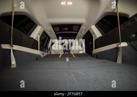 moscow, russia - december 24, 2019: rear row of seats folded in flat flor. empty interior of saloon premium SUV Mercedes GLS class in night shooting. Stock Photo