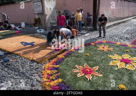 Intricate and vibrant sawdust alfombras decorate the cobblestone streets of Antigua, Guatemala in preparation for the Semana Santa processions. Stock Photo