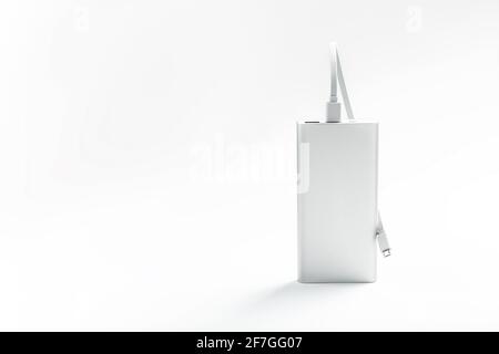 Powerbank for charging mobile devices with cable, on a white background. Universal external battery for gadgets. Isolate Stock Photo