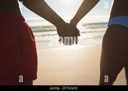 Midsection of african american couple in love holding hands Stock Photo