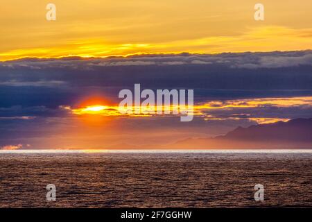 A sunset over the NW Pacific coast near Prince of Wales Island, Alaska, USA - Viewed from a cruise ship sailing the Inside Passage Stock Photo