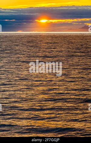 A sunset over the NW Pacific coast near Prince of Wales Island, Alaska, USA - Viewed from a cruise ship sailing the Inside Passage Stock Photo