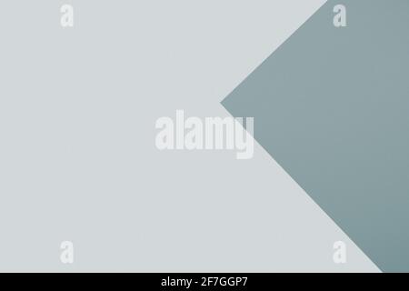 Combination of paper sheets with two shades of grey overlaid on each other in triangle shape. Abstract background Stock Photo