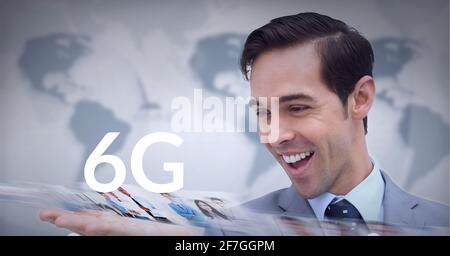 Composition of the word 6g over caucasian man smiling with world map in background. global technology, digital interface, connection and communication Stock Photo
