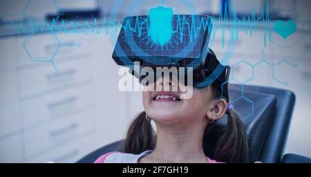 Composition of data processing over caucasian girl using vr headset in background Stock Photo