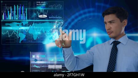 Composition of caucasian man using technological device with statistics and data Stock Photo
