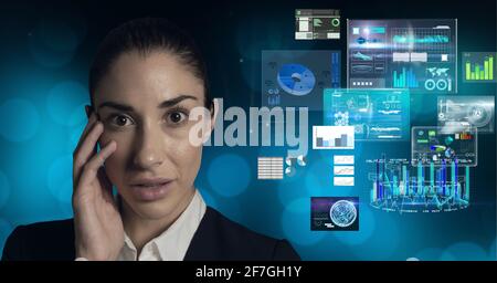 Composition of data processing over caucasian woman looking at camera in background Stock Photo