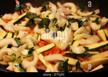 Close-up of a pile of chopped vegetables, including carrot, onion, Bok choy, celery. Stock Photo