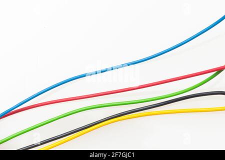 Colored wires, copper wires covered by colored plastic for electrical and technological connections. Cables on white background. Basic colors. Stock Photo