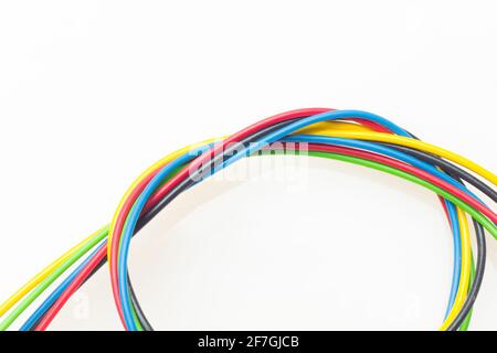 Colored wires, copper wires covered by colored plastic for electrical and technological connections. Cables on white background. Basic colors. Stock Photo