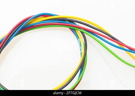 Colored wires, copper wires covered by colored plastic for electrical and technological connections. Cables on white background. Basic colors. Stock Photo