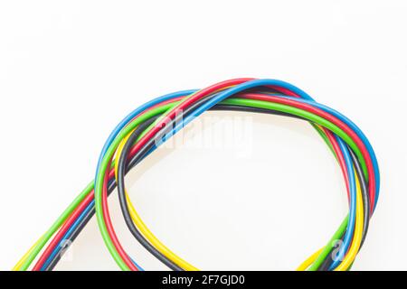 Colored wires, copper wires covered by colored plastic for electrical and technological connections. Cables on white background. Basic colors. Stock Photo