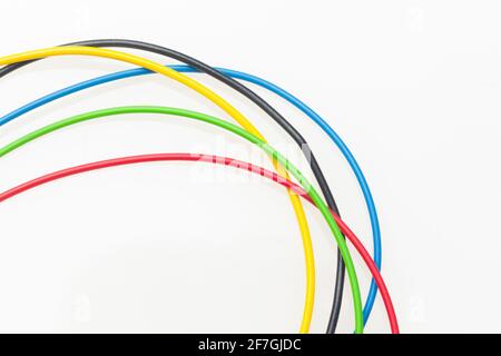 Colored wires, copper wires covered by colored plastic for electrical and technological connections. Cables on white background. Basic colors. Stock Photo
