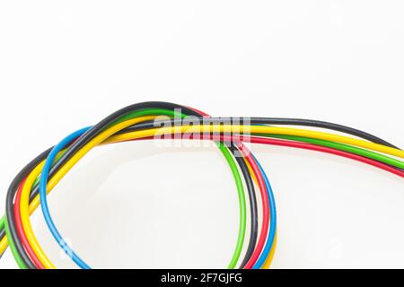 Colored wires, copper wires covered by colored plastic for electrical and technological connections. Cables on white background. Basic colors. Stock Photo