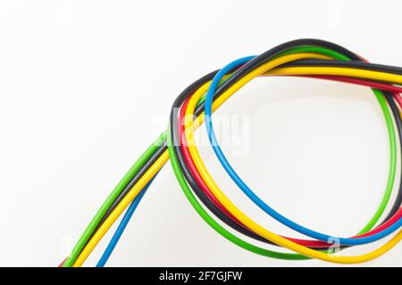 Colored wires, copper wires covered by colored plastic for electrical and technological connections. Cables on white background. Basic colors. Stock Photo