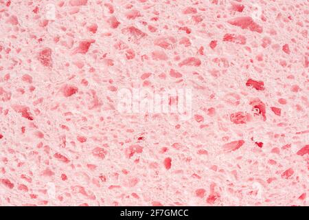 Sponge pink texture background. Bath spongy surface. Kitchen sponge material closeup. Foam rubber detail. Close up Stock Photo