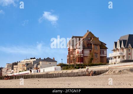 Le Crotoy, France - September 11 2020: Pretty half-timbered seaside house located oposite the bathing boxes on the beach. Stock Photo