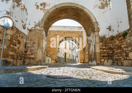 Entrance through medieval walls to historic downtown of Faro, Algarve, southern Portugal Stock Photo