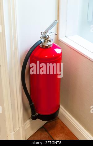 Fire extinguisher system on the wall background, powerful emergency equipment for industrial Stock Photo