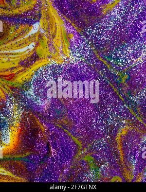 Multicolored acrylic backdrop sprinkled with purple sparkles. Contemporary creativity. Colorful avant-garde rich texture. A background made up of many Stock Photo