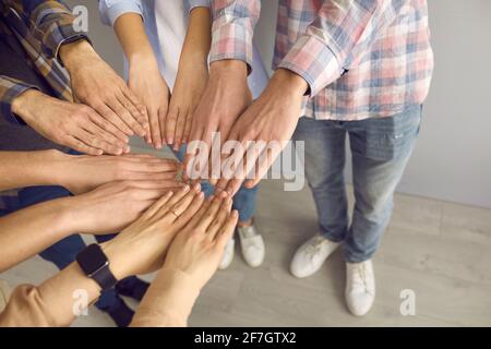 Closeup teenagers palm together in circle show team spirit shot with copy space Stock Photo