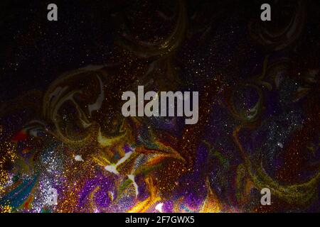 Multi-colored dark background sprinkled with purple and gold sparkles with streaks and waves. Contemporary creativity. A colorful avant-garde painting Stock Photo