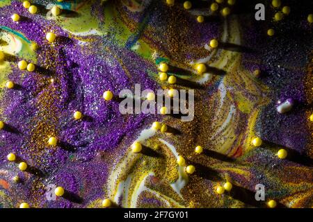 Multicolored acrylic background with curls sprinkled with purple and gold sparkles. Contemporary creativity. A colorful avant-garde painting with rich Stock Photo