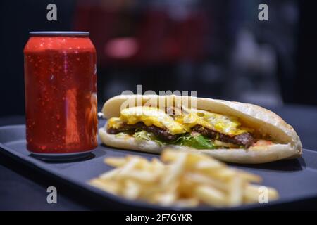 Ground meat sandwich with eggs. And french fries. And a soft drink. Background for restaurants Stock Photo