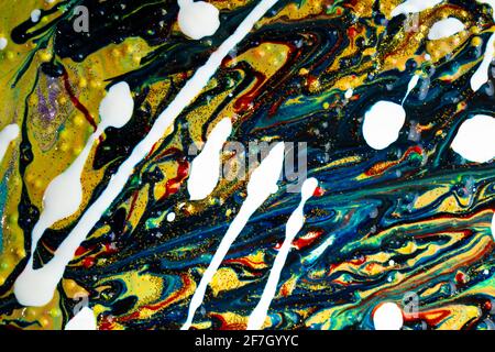 Multicolored acrylic background with curls sprinkled with purple and gold sparkles. Contemporary creativity. A colorful avant-garde painting with rich Stock Photo