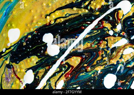 Multicolored acrylic background with curls sprinkled with purple and gold sparkles. Contemporary creativity. A colorful avant-garde painting with rich Stock Photo