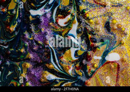 Multicolored acrylic background with dark streaks and white spots, sprinkled with glitter. Modern creativity. A colorful avant-garde painting with ric Stock Photo