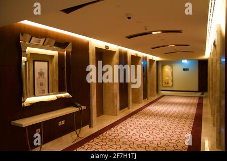 DUBAI, UNITED ARAB EMIRATES - JUN 16, 2019: Long dark corridor in a luxury hotel next to the elevator lobby Stock Photo