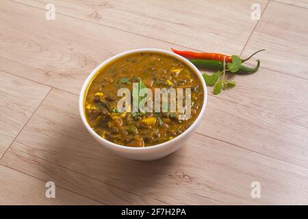 Dal Makhani at dark background. Dal Makhani - traditional indian cuisine puree dish with urad beans, red beans, butter, spices and cream. Stock Photo