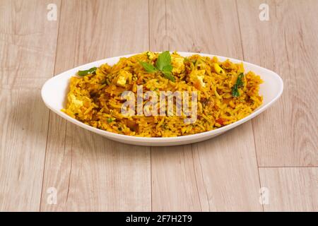 vegetarian paneer biryani at light blue background. paneer biryani is traditional veg indian cuisine dish with paneer cheese, basmati rice, masala, ch Stock Photo