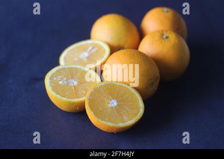 Kinnows and Sliced Kinnows which looks like Orange. It is a high yield, seedless mandarin hybrid orange like fruit cultivated extensively in the wider Stock Photo