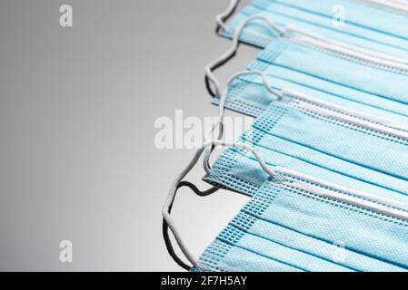 Surgical masks with rubber ear straps. A typical three-layer surgical mask to cover the mouth and nose. Protection against bacteria.Concept of protect Stock Photo